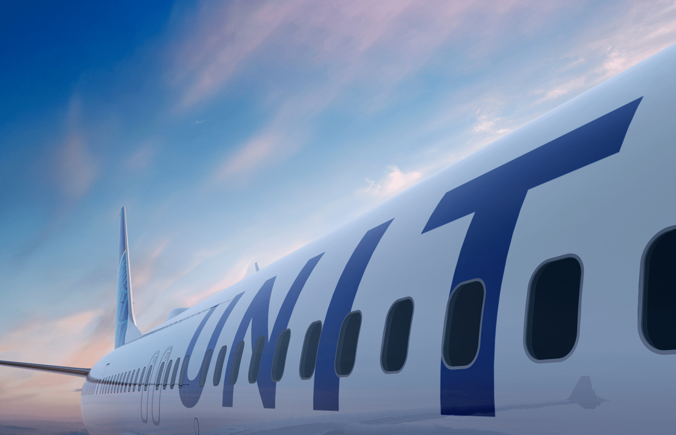 Close-up view along the side of a United Airlines aircraft in flight, showing the large blue lettering and passenger windows against a colorful sky.