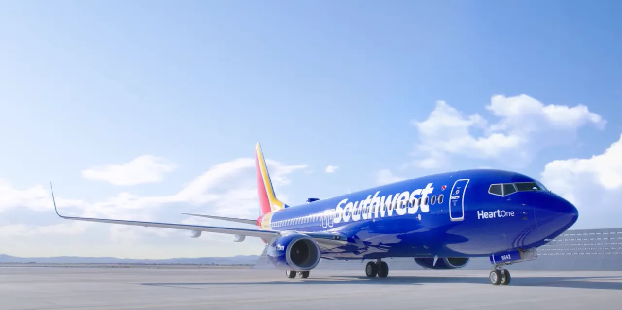 Southwest Airlines Boeing 737 passenger jet in the bright blue Heart livery taxiing on the airport tarmac under a sunny sky